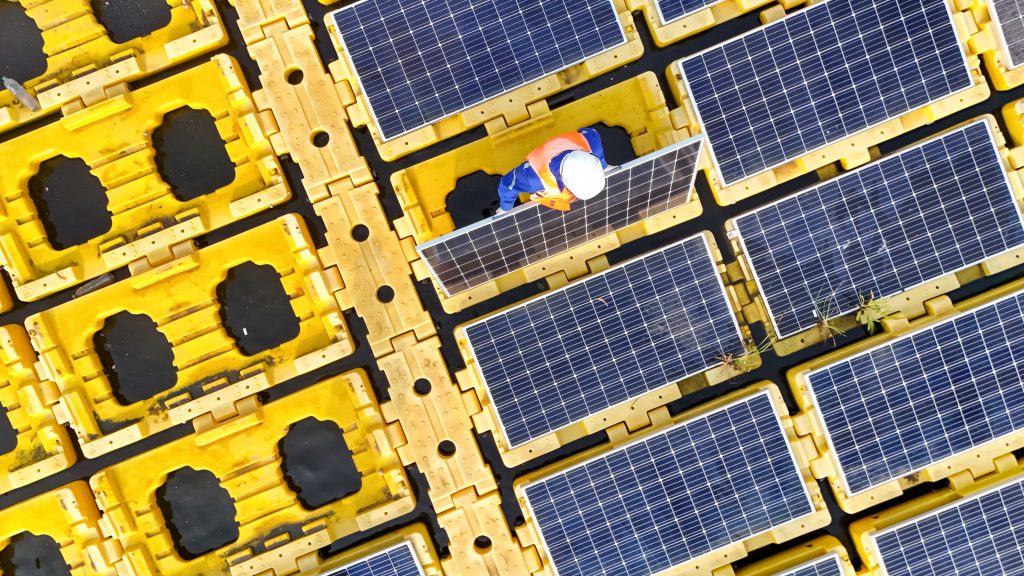Men technicians mounting photovoltaic solar at floating solar station