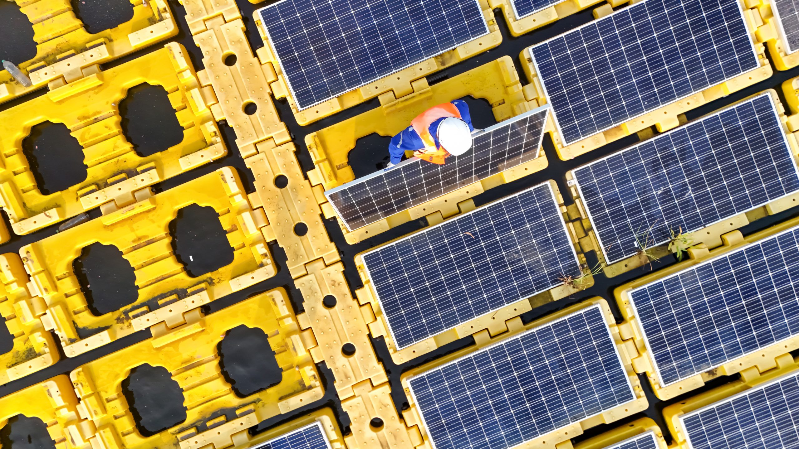Men technicians mounting photovoltaic solar at floating solar station